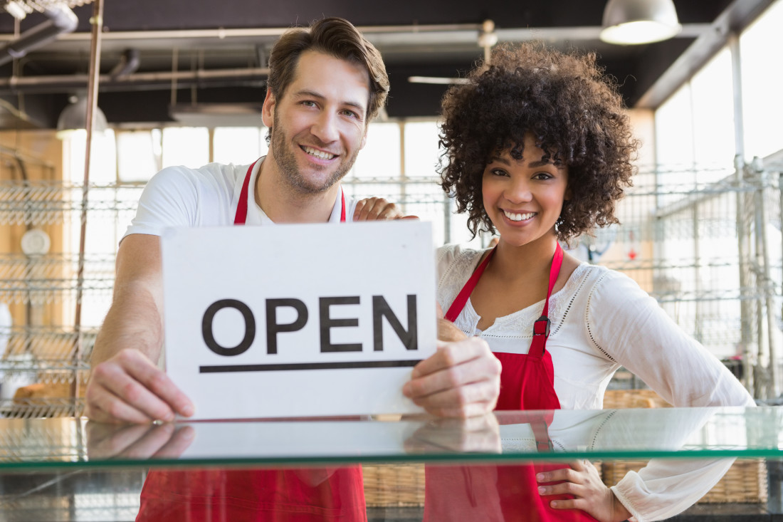 couple with open sign