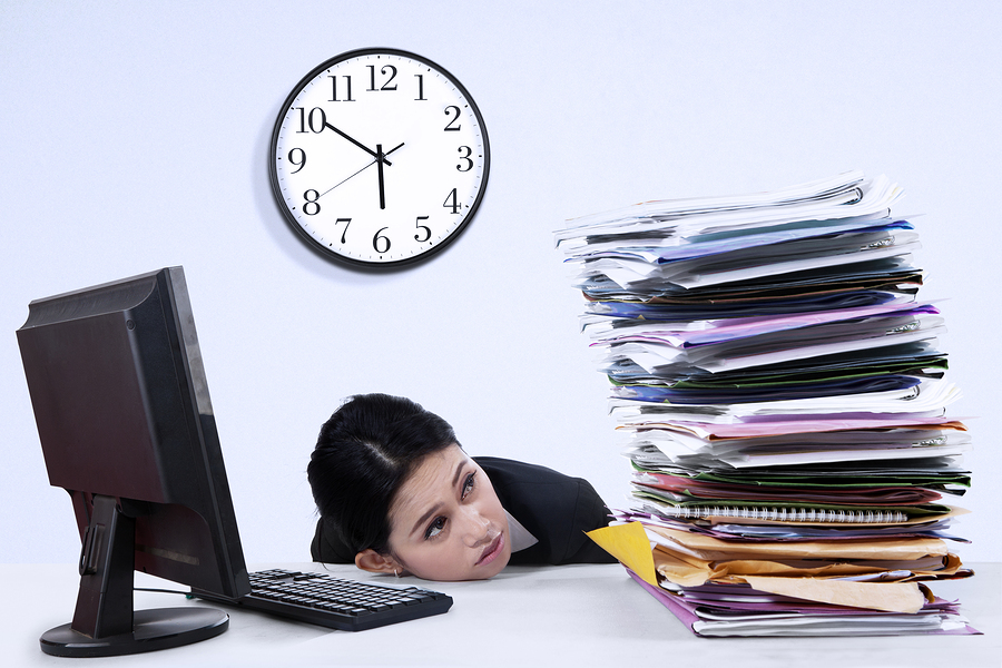 Businesswoman With Stack Of Document