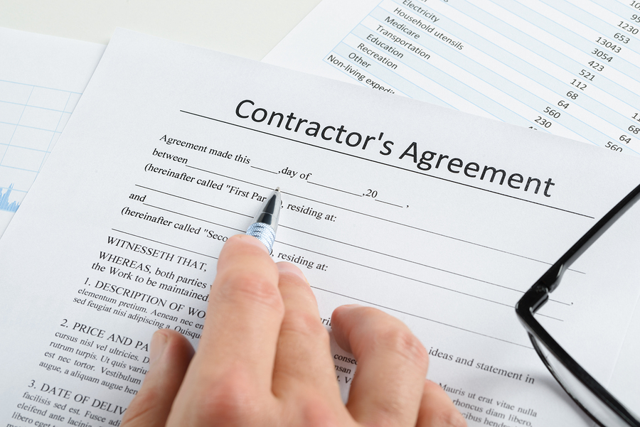 Hand With Pen And Eyeglasses Over Agreement