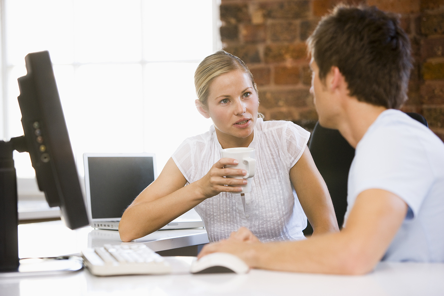 Two work colleagues sat together talking