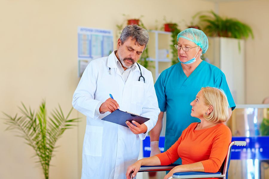 Doctor And Surgeon Consulting Patient About Medication