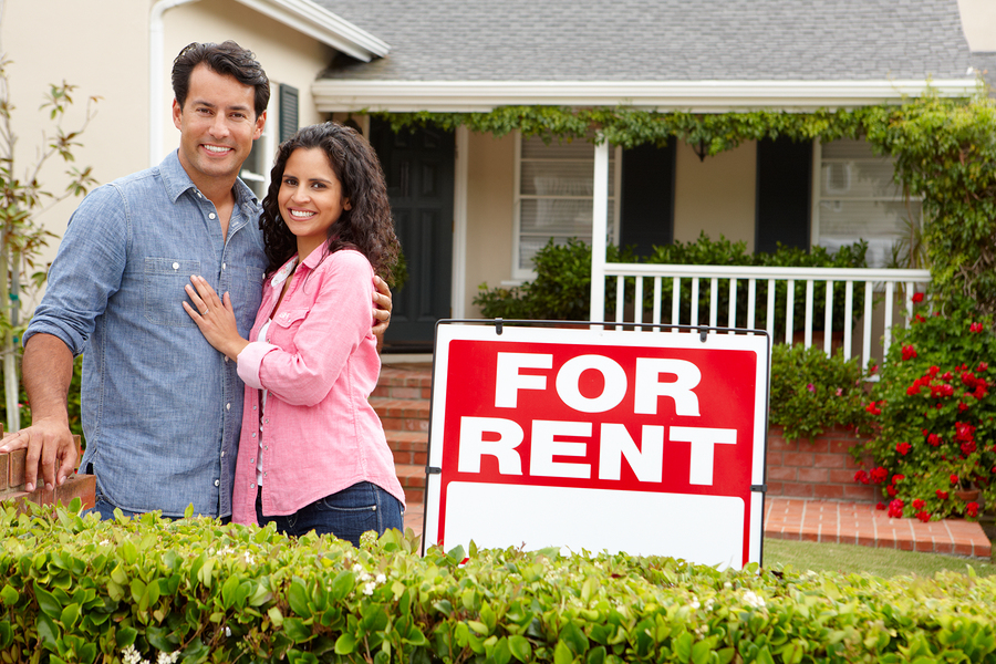 Hispanic couple outside home for rent