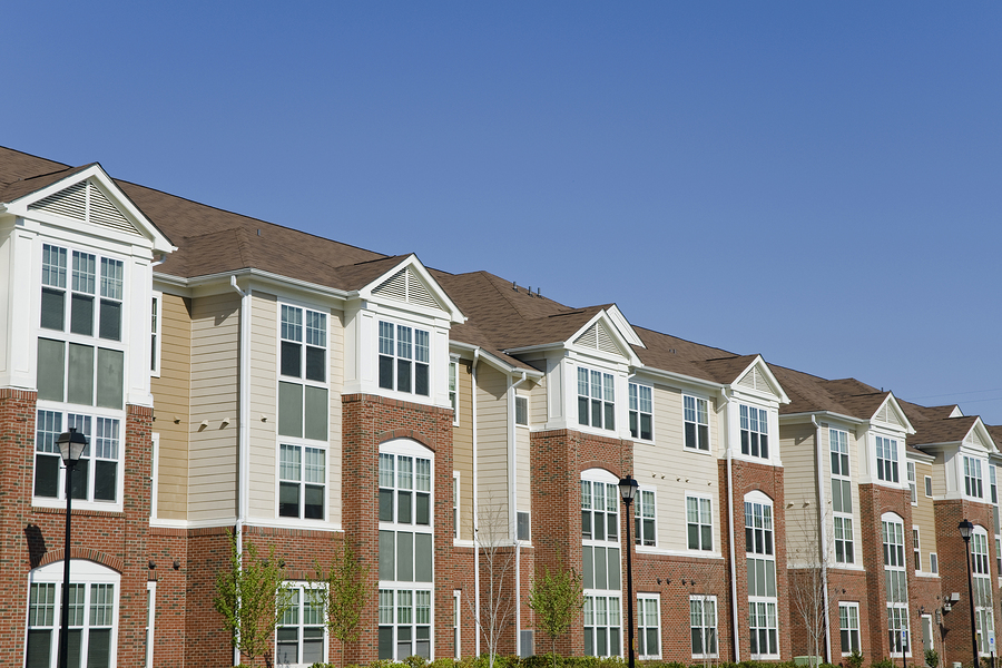 Large rental suburban apartment building detail on perfect spring day