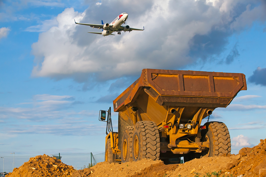 Prague ,Czech Republic - June 14, 2011:Yellow Cut truck on the highway construction in front of Ruzyne Airport.The Cat brand is the cornerstone Caterpillar representing products and services made by Caterpillar. ** Note: Visible grain at 100%, best at